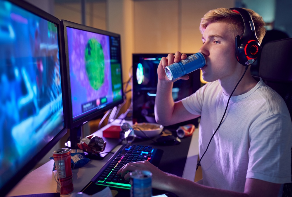 teenage,boy,drinking,caffeine,energy,drink,gaming,at,home,using